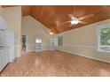 Open-concept living room with hardwood floors, light yellow walls, and vaulted wood ceiling at 222 Sagamore Dr, Louisburg, NC 27549