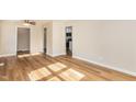 Open living area with vinyl floors, ceiling fan and view into the kitchen at 2312 Shannon St, Raleigh, NC 27610