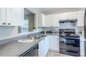 Bright kitchen features white cabinets, stainless steel appliances, and sleek countertops at 2459 Bay Harbor Dr, Raleigh, NC 27604
