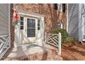 Inviting entrance with a white trimmed door, patterned sidelights, and brick steps at 2835 Bedfordshire Ct, Raleigh, NC 27604