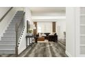 Inviting living room featuring modern finishes, staircase, and great natural light at 308 Canyon Spring Trl, Wake Forest, NC 27587