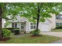 Charming single-story home featuring light siding, a one car garage, and a well-maintained front yard with mature tree at 3108 Forrestal Dr, Durham, NC 27703