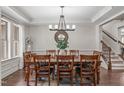 Elegant dining room features a large wooden table, decorative mirror, and stylish chandelier at 3304 Rockland Ridge Dr, Cary, NC 27519