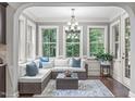 Bright sunroom with large windows, comfortable seating, and a view of the surrounding greenery at 3304 Rockland Ridge Dr, Cary, NC 27519