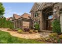 Charming brick and stone home featuring a stone walkway leading to the front door and lush landscaped garden at 3601 Nightfall Ct, Raleigh, NC 27607