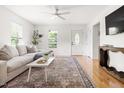 Bright living room features hardwood floors, neutral walls, a large sofa, and natural light at 407 Sparella St, Durham, NC 27703