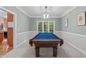 Well-lit game room with a blue felt pool table and neutral-toned walls at 408 Dairy Farm Dr, Hillsborough, NC 27278