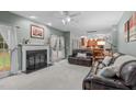 Inviting living room with a cozy fireplace, plush seating, and an open floor plan at 408 Dairy Farm Dr, Hillsborough, NC 27278