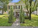 Charming two-story home features a well-manicured lawn and a welcoming front porch with brick and stone accents at 4104 Panther Creek Pkwy, Durham, NC 27704