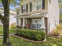 Charming two-story home features a well-manicured lawn and a welcoming front porch with brick and stone accents at 4104 Panther Creek Pkwy, Durham, NC 27704