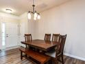 Traditional dining room featuring a wooden table and chairs, complemented by new floors and a stylish light fixture at 4206 Camden Woods Ct, Raleigh, NC 27612