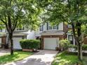 Charming two-story townhome with brick accents, a garage, and a well-manicured lawn with mature landscaping at 4206 Camden Woods Ct, Raleigh, NC 27612