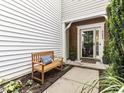 Inviting front porch with a wooden bench and landscaping, offering a warm welcome to the home at 4206 Camden Woods Ct, Raleigh, NC 27612
