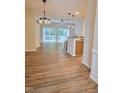 Bright living room with wood floors, open floor plan and sliding doors to a deck at 4206 Camden Woods Ct, Raleigh, NC 27612