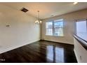 Bright dining area featuring hardwood floors, modern chandelier, and large windows at 4716 Princess Lita Way, Raleigh, NC 27610