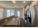 Well-lit kitchen area with stainless steel appliances, granite countertops and natural light at 4716 Princess Lita Way, Raleigh, NC 27610