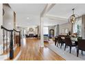 Open-concept living and dining area with hardwood floors and lots of natural light at 4953 Mashpee Ln, Apex, NC 27539