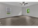 Bright and airy bedroom with sleek floors and plenty of natural light from the two windows at 501 Benton Dr, Oxford, NC 27565