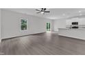 Spacious living room features an open floorplan, ample natural light, and views of the backyard and kitchen at 501 Benton Dr, Oxford, NC 27565