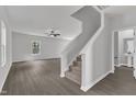 Bright, open-concept living area features sleek floors and a view of the staircase and a powder room at 501 Benton Dr, Oxford, NC 27565