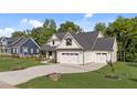 Beautiful home with three-car garage, lush lawn and welcoming facade at 525 Allesandra Dr, Clayton, NC 27527