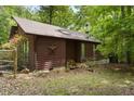Rustic home exterior with charming star detail and neatly stacked firewood at 5604 Hideaway Dr, Chapel Hill, NC 27516