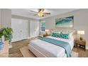 Serene main bedroom with modern decor, hardwood floors, a ceiling fan, and ample closet space at 5804 Heatherbrook Cir, Raleigh, NC 27612