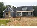 Lovely home showcasing blue siding, a brick foundation, and a welcoming front porch with classic columns at 60 Stream View Way, Spring Hope, NC 27882