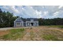 Charming two-story home with a combination of blue siding for a timeless, classic exterior at 60 Stream View Way, Spring Hope, NC 27882