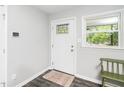 Bright foyer with a decorative front door and modern flooring and wall colors at 601 Longfellow St, Fuquay Varina, NC 27526