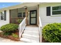 Inviting front porch with white railings and a screen door, leading to the entrance at 601 Longfellow St, Fuquay Varina, NC 27526
