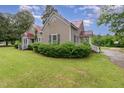 Charming home with a red roof and lush green lawn at 6720 Dwight Rowland Rd, Willow Springs, NC 27592