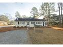 Charming single story home featuring traditional architecture, brick accents and mature landscaping at 75 Hartwell Cir, Lillington, NC 27546