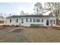 Inviting single-story home boasting classic shutters, lush landscaping, and a welcoming front entrance at 75 Hartwell Cir, Lillington, NC 27546
