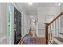 Bright foyer featuring hardwood floors, decorative molding, and a staircase at 7929 Pine Timber Dr, Raleigh, NC 27613
