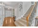 Bright and open foyer with hardwood floors and a staircase leading to the upper level at 8504 Delavan Cir, Raleigh, NC 27613