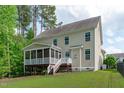 Spacious backyard showcasing a screened porch and ample green space perfect for outdoor entertaining and relaxation at 851 Dotson Way, Apex, NC 27523