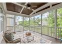 Inviting screened porch with comfortable seating, wood ceiling, and views of the lush backyard at 851 Dotson Way, Apex, NC 27523