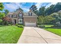 Charming home with a spacious driveway, two-car garage, and lush green lawn at 9 Sandhill Ln, Durham, NC 27713
