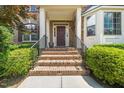 Inviting front entrance with brick steps, black railings, and well-maintained landscaping at 9 Sandhill Ln, Durham, NC 27713