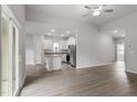 Open-concept living room featuring stainless appliances, granite counters, and white cabinetry at 910 Rhino Bnd, Oxford, NC 27565