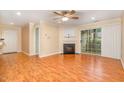 Cozy living area features a fireplace, ceiling fan, and sliding door to the outside at 1002 Kingswood Dr # A, Chapel Hill, NC 27517