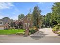 Charming brick house with mature landscaping and a long driveway, perfect for a Gathering at 1010 Mill Pointe Way, Elon, NC 27244