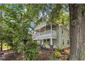 Charming two-story home with a vibrant yellow front door and welcoming double-decker front porches at 1011 Burch Ave, Durham, NC 27701