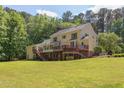 Expansive backyard view showcasing the home's multi-tiered deck and screened porch, perfect for entertaining at 117 Carolina Forest Rd, Chapel Hill, NC 27516