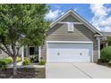 Charming home featuring a covered entryway, well-manicured landscaping and an attached one car garage at 118 Rosedale Creek Dr, Durham, NC 27703