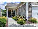 Charming home featuring a covered entryway, well-manicured landscaping and an attached one car garage at 118 Rosedale Creek Dr, Durham, NC 27703