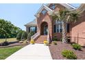 Inviting front entrance with well-maintained landscaping and a charming arched entryway at 120 Gentle Rain Dr, Garner, NC 27529