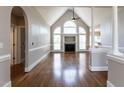 Spacious living room with high ceilings, elegant columns, and fireplace at 120 Gentle Rain Dr, Garner, NC 27529