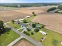 Expansive aerial view showcases a rural property with multiple structures, open fields, and a serene, private setting at 12294 Nc Hwy 96 S, Dunn, NC 28334